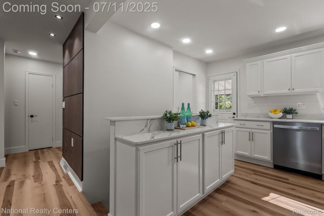 1089 Tecumseh Ave, Waterford, MI 48327 - kitchen featuring stainless steel dishwasher, light wood finished floors, white cabinetry, recessed lighting, and light stone counters