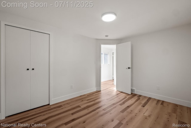 1089 Tecumseh Ave, Waterford, MI 48327 - unfurnished bedroom with wood finished floors and a closet