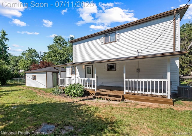 1089 Tecumseh Ave, Waterford, MI 48327 - back of property with a yard, a shed, and a wooden deck