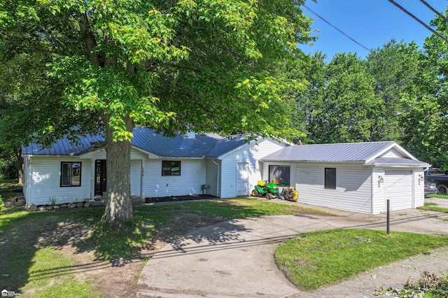 296 S Saginaw St, Montrose, MI 48457 - ranch-style home with driveway, a garage, a metal roof, and a front yard