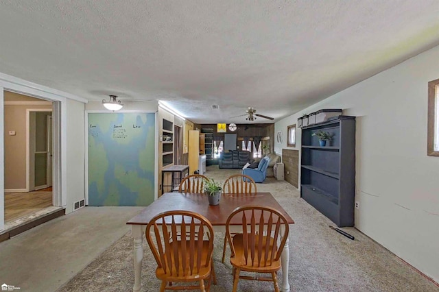 296 S Saginaw St, Montrose, MI 48457 - dining area with a textured ceiling, ceiling fan, and a fireplace