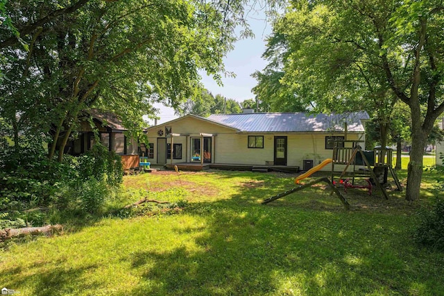 296 S Saginaw St, Montrose, MI 48457 - back of property featuring a yard and a metal roof