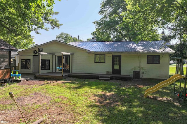 296 S Saginaw St, Montrose, MI 48457 - rear view of property with a yard, a metal roof, a playground, and a wooden deck