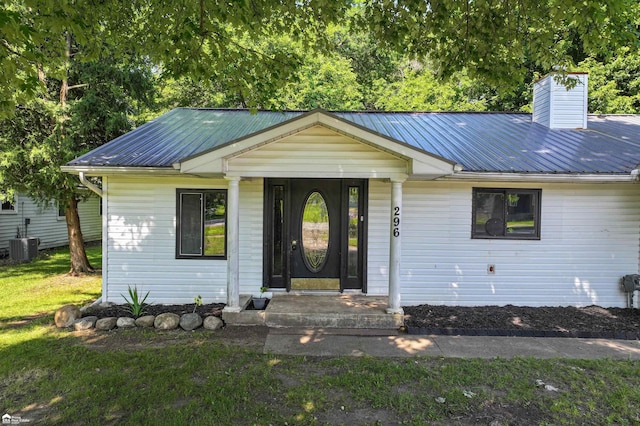 296 S Saginaw St, Montrose, MI 48457 - ranch-style home featuring a metal roof, a front yard, and a chimney