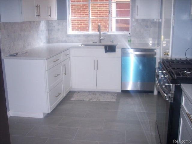 20003 Lichfield Rd, Detroit, MI 48221 - kitchen with stainless steel appliances, tasteful backsplash, white cabinetry, and light countertops