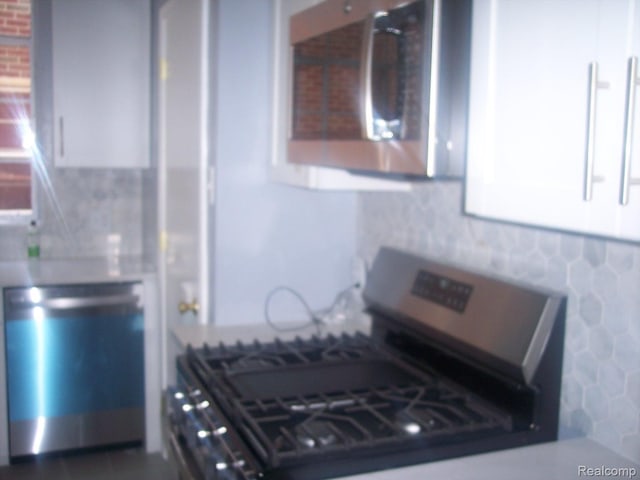 20003 Lichfield Rd, Detroit, MI 48221 - kitchen featuring stainless steel appliances, white cabinets, and light countertops