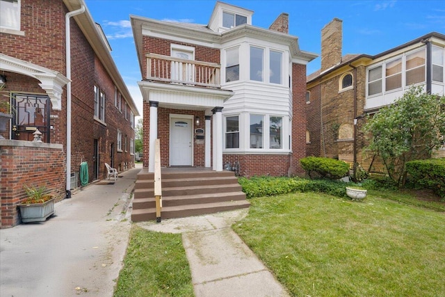 2475 Hazelwood St, Detroit, MI 48206 - view of front of house with a balcony, brick siding, and a front yard