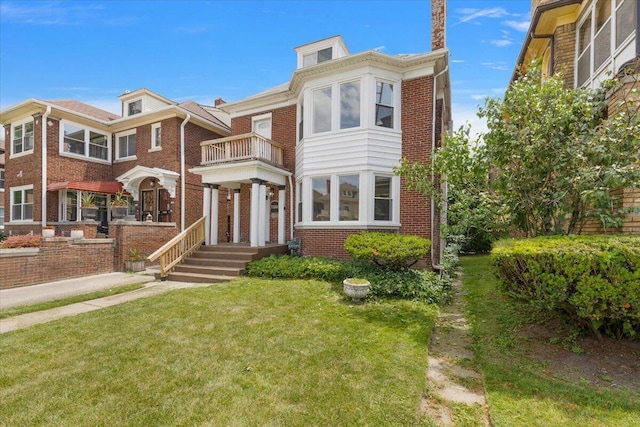 2475 Hazelwood St, Detroit, MI 48206 - view of front facade with brick siding, a front yard, and a balcony