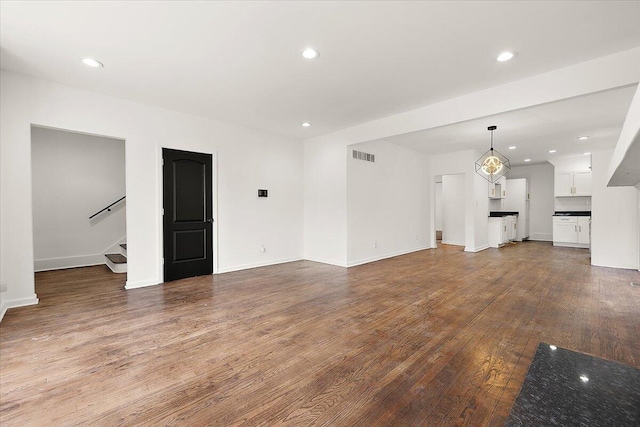 2475 Hazelwood St, Detroit, MI 48206 - unfurnished living room featuring wood finished floors, stairs, and recessed lighting