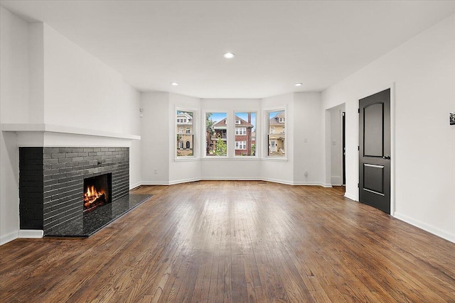 2475 Hazelwood St, Detroit, MI 48206 - unfurnished living room with hardwood / wood-style flooring, a brick fireplace, and recessed lighting