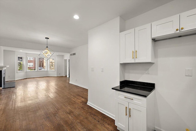 2475 Hazelwood St, Detroit, MI 48206 - kitchen with white cabinetry, dark wood-style floors, recessed lighting, open floor plan, and decorative light fixtures