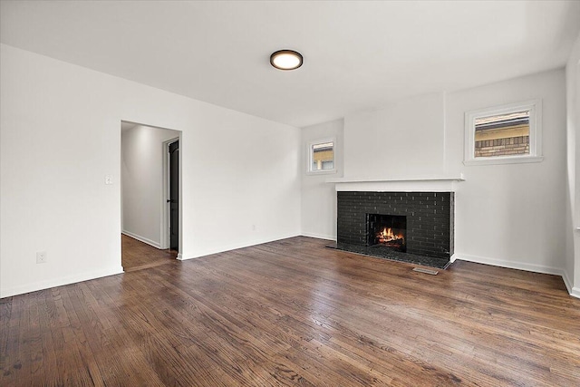 2475 Hazelwood St, Detroit, MI 48206 - unfurnished living room featuring a brick fireplace and wood finished floors