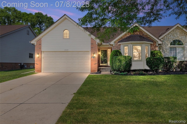 57349 Megan Dr, Washington, MI 48094 - view of front facade featuring brick siding, concrete driveway, and a lawn