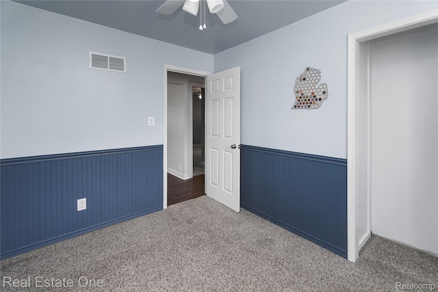 13776 Leroy St, Southgate, MI 48195 - unfurnished bedroom with a wainscoted wall, carpet flooring, ceiling fan, and wooden walls
