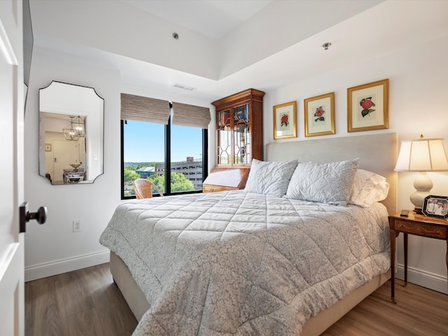 111 N Ashley St Unit 513, Ann Arbor, MI 48104 - bedroom with wood finished floors and access to exterior