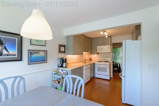 2746 Page Ave, Ann Arbor, MI 48104 - kitchen featuring white appliances, wood finished floors, light countertops, gray cabinetry, and decorative light fixtures