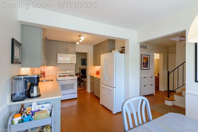 2746 Page Ave, Ann Arbor, MI 48104 - kitchen featuring white appliances, wood finished floors, light countertops, and gray cabinetry