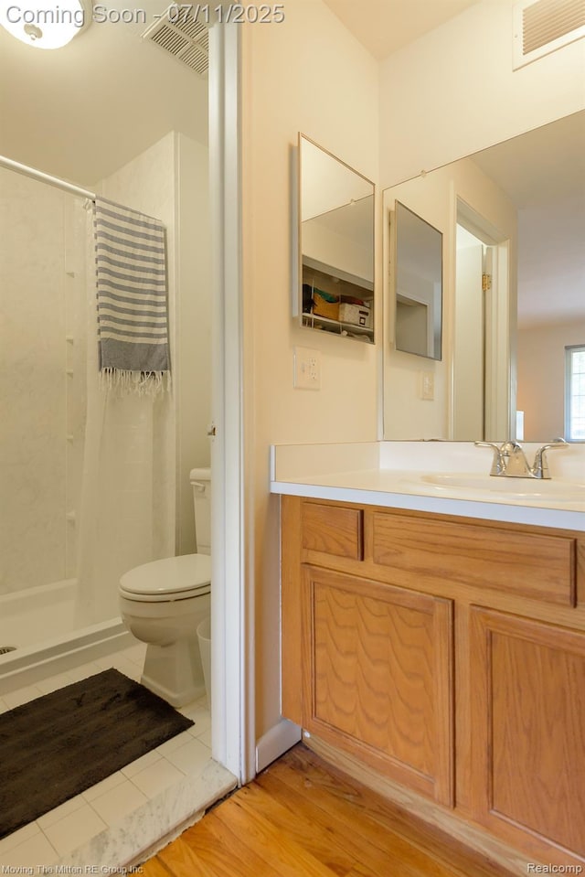 2746 Page Ave, Ann Arbor, MI 48104 - bathroom featuring a shower with shower curtain, vanity, and wood finished floors