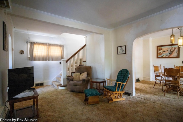 892 W Forest Ave, Muskegon, MI 49441 - living area with carpet, crown molding, stairs, and arched walkways