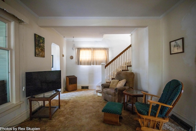 892 W Forest Ave, Muskegon, MI 49441 - carpeted living area with ornamental molding, arched walkways, and stairway