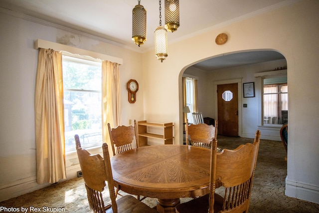 892 W Forest Ave, Muskegon, MI 49441 - dining space with arched walkways, healthy amount of natural light, and ornamental molding