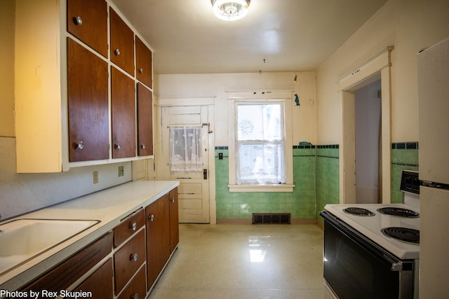 892 W Forest Ave, Muskegon, MI 49441 - kitchen featuring white appliances, light countertops, and light flooring