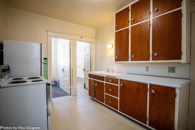 892 W Forest Ave, Muskegon, MI 49441 - kitchen featuring white appliances, light countertops, brown cabinetry, and light flooring