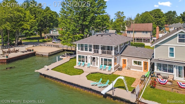 106 St Clair River Dr, Algonac, MI 48001 - back of house with a water view, a sunroom, and a shingled roof
