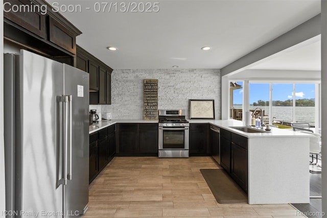 106 St Clair River Dr, Algonac, MI 48001 - kitchen featuring appliances with stainless steel finishes, recessed lighting, light countertops, light wood-style flooring, and a water view