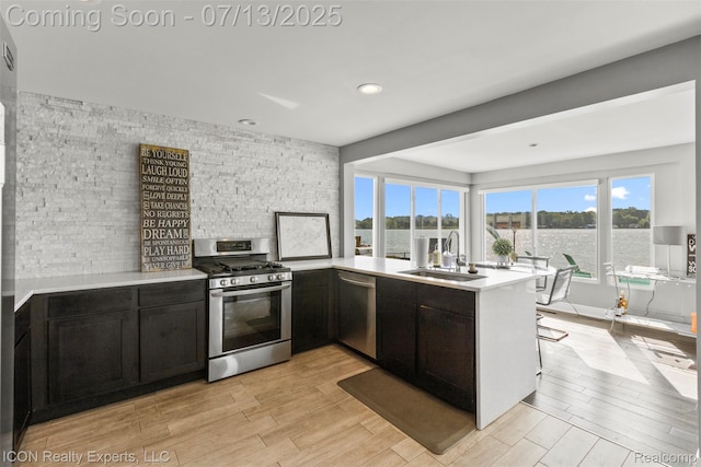 106 St Clair River Dr, Algonac, MI 48001 - kitchen featuring stainless steel appliances, light wood-style floors, light countertops, a peninsula, and recessed lighting