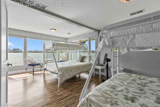 106 St Clair River Dr, Algonac, MI 48001 - bedroom featuring multiple windows, wood finished floors, and a water view