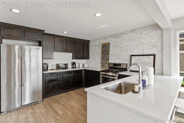 106 St Clair River Dr, Algonac, MI 48001 - kitchen featuring stainless steel appliances, backsplash, recessed lighting, dark brown cabinetry, and light wood-style flooring
