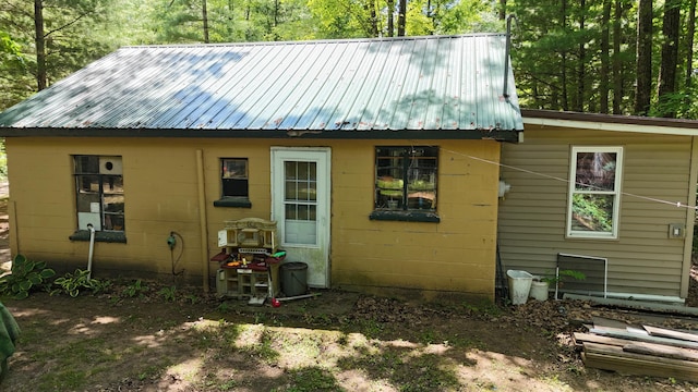 17644 Stronach Dam Rd, Wellston, MI 49689 - back of property featuring concrete block siding and a metal roof