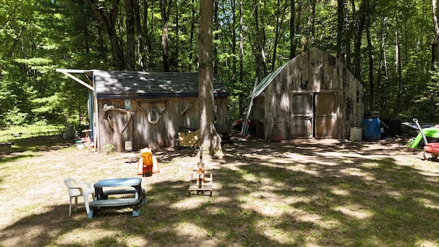17644 Stronach Dam Rd, Wellston, MI 49689 - view of yard with a storage shed and a wooded view