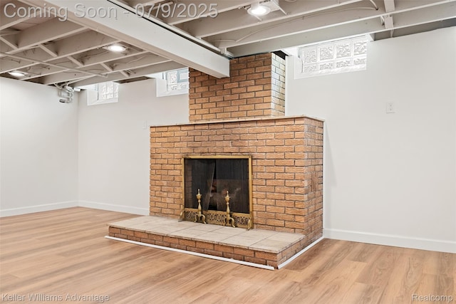 44249 Donley Dr, Sterling Heights, MI 48314 - below grade area featuring wood finished floors and a fireplace