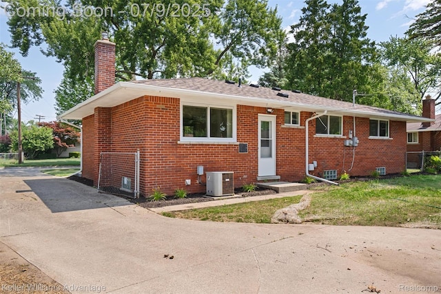44249 Donley Dr, Sterling Heights, MI 48314 - bungalow-style home featuring a chimney, brick siding, concrete driveway, and a shingled roof