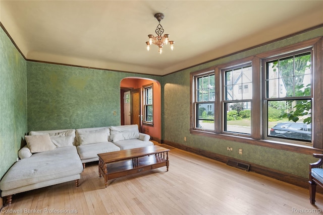 122 Linden Ct, Ypsilanti, MI 48197 - living area with arched walkways, light wood-style floors, and a chandelier