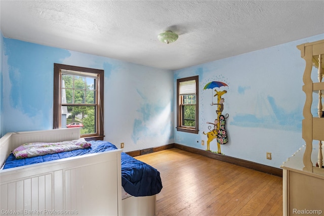 122 Linden Ct, Ypsilanti, MI 48197 - bedroom featuring hardwood / wood-style floors and a textured ceiling
