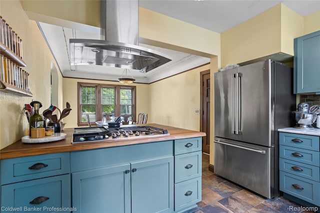 122 Linden Ct, Ypsilanti, MI 48197 - kitchen featuring stainless steel appliances, wood counters, blue cabinets, exhaust hood, and dark stone finish floors