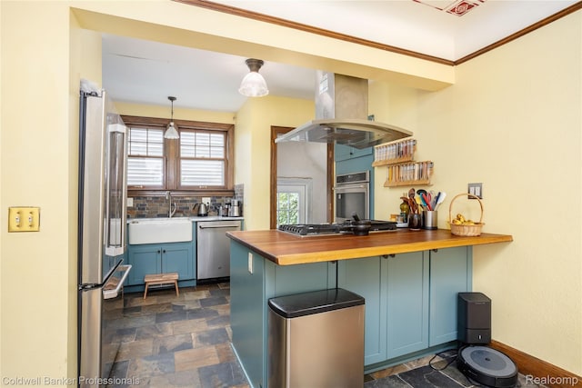 122 Linden Ct, Ypsilanti, MI 48197 - kitchen with island exhaust hood, appliances with stainless steel finishes, wooden counters, stone finish flooring, and a peninsula