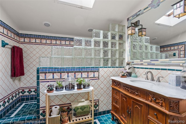 122 Linden Ct, Ypsilanti, MI 48197 - bathroom with a skylight, tile walls, vanity, tile patterned floors, and a walk in shower