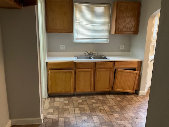 8518 Sussex St, Detroit, MI 48228 - kitchen featuring arched walkways, light countertops, and brick patterned floors