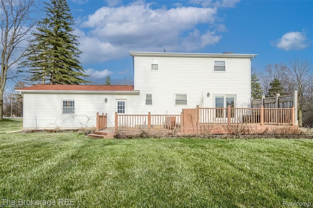 11247 Irish Rd, Otisville, MI 48463 - rear view of house featuring a deck and a lawn