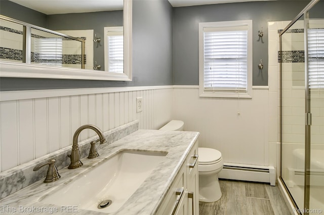 11247 Irish Rd, Otisville, MI 48463 - full bathroom featuring a baseboard heating unit, a shower stall, wood finished floors, wainscoting, and vanity