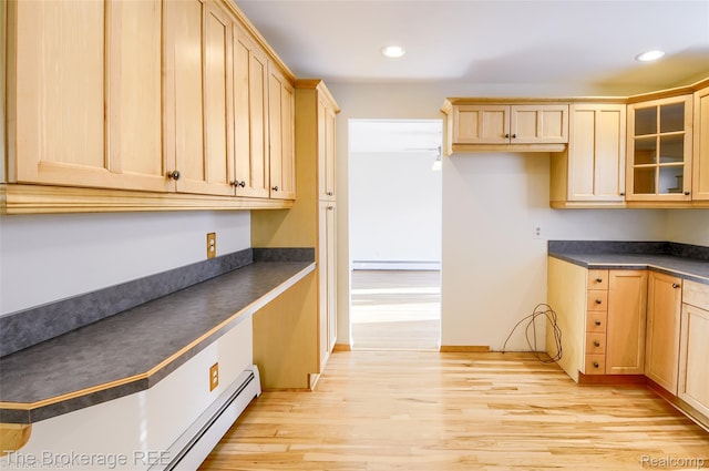 11247 Irish Rd, Otisville, MI 48463 - kitchen with dark countertops, a baseboard heating unit, light brown cabinetry, light wood-type flooring, and recessed lighting