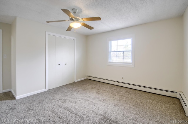 11247 Irish Rd, Otisville, MI 48463 - unfurnished bedroom featuring baseboard heating, carpet, a closet, a textured ceiling, and a ceiling fan