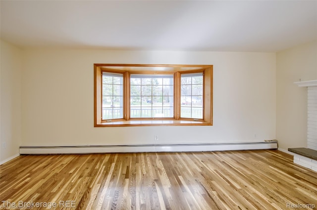 11247 Irish Rd, Otisville, MI 48463 - spare room with wood finished floors, baseboard heating, and a fireplace