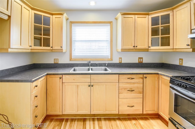 11247 Irish Rd, Otisville, MI 48463 - kitchen featuring light brown cabinets, stainless steel range with gas stovetop, light wood-style floors, dark countertops, and recessed lighting