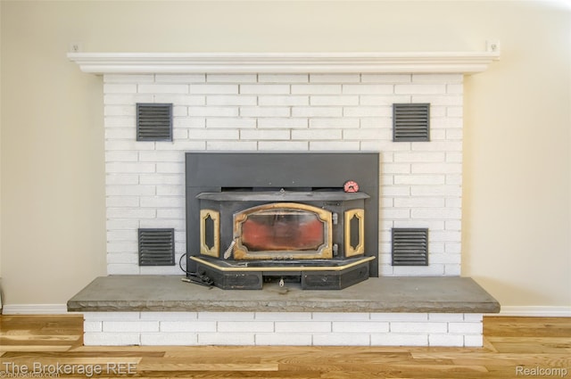 11247 Irish Rd, Otisville, MI 48463 - detailed view of wood finished floors and a wood stove