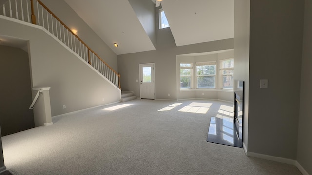 41664 Tera Ln, Novi, MI 48375 - unfurnished living room featuring high vaulted ceiling, carpet, plenty of natural light, and stairway